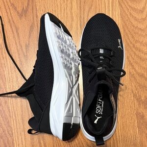 Puma women’s Black and White Sneakers